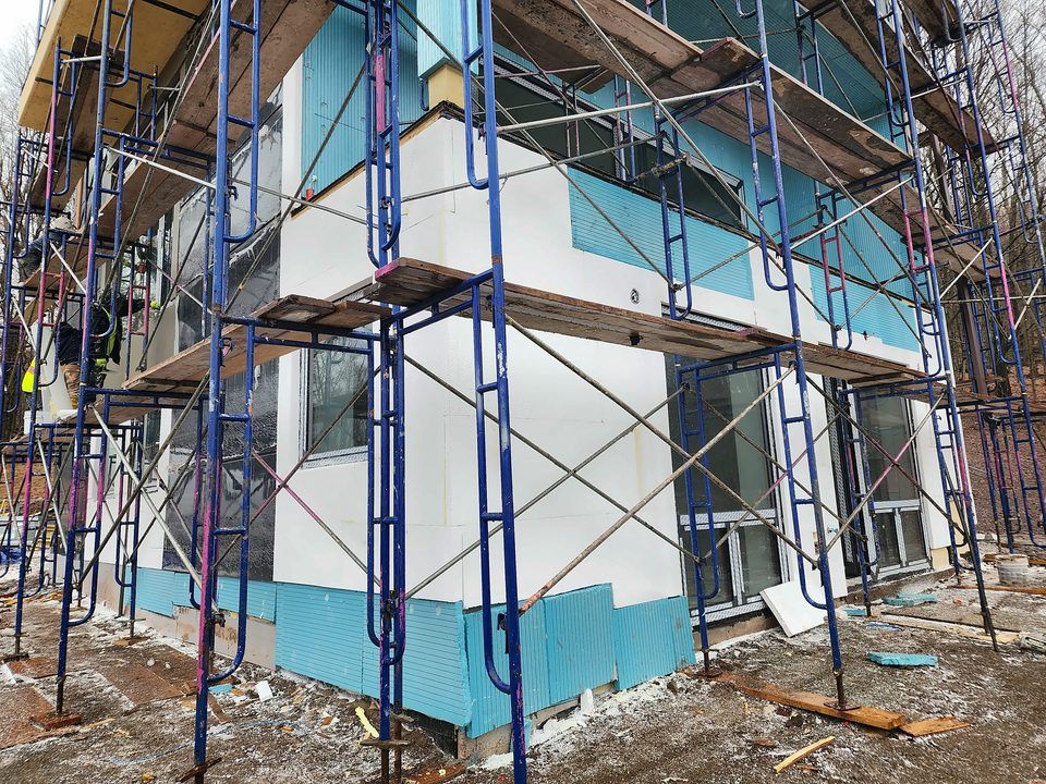 Residential EIFS installation - Foam board going up on scaffold, 2023.
